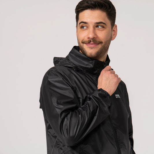 Man wearing a black waterproof and wind proof jacket showing the integrated hood with a brand logo on a light gray background
