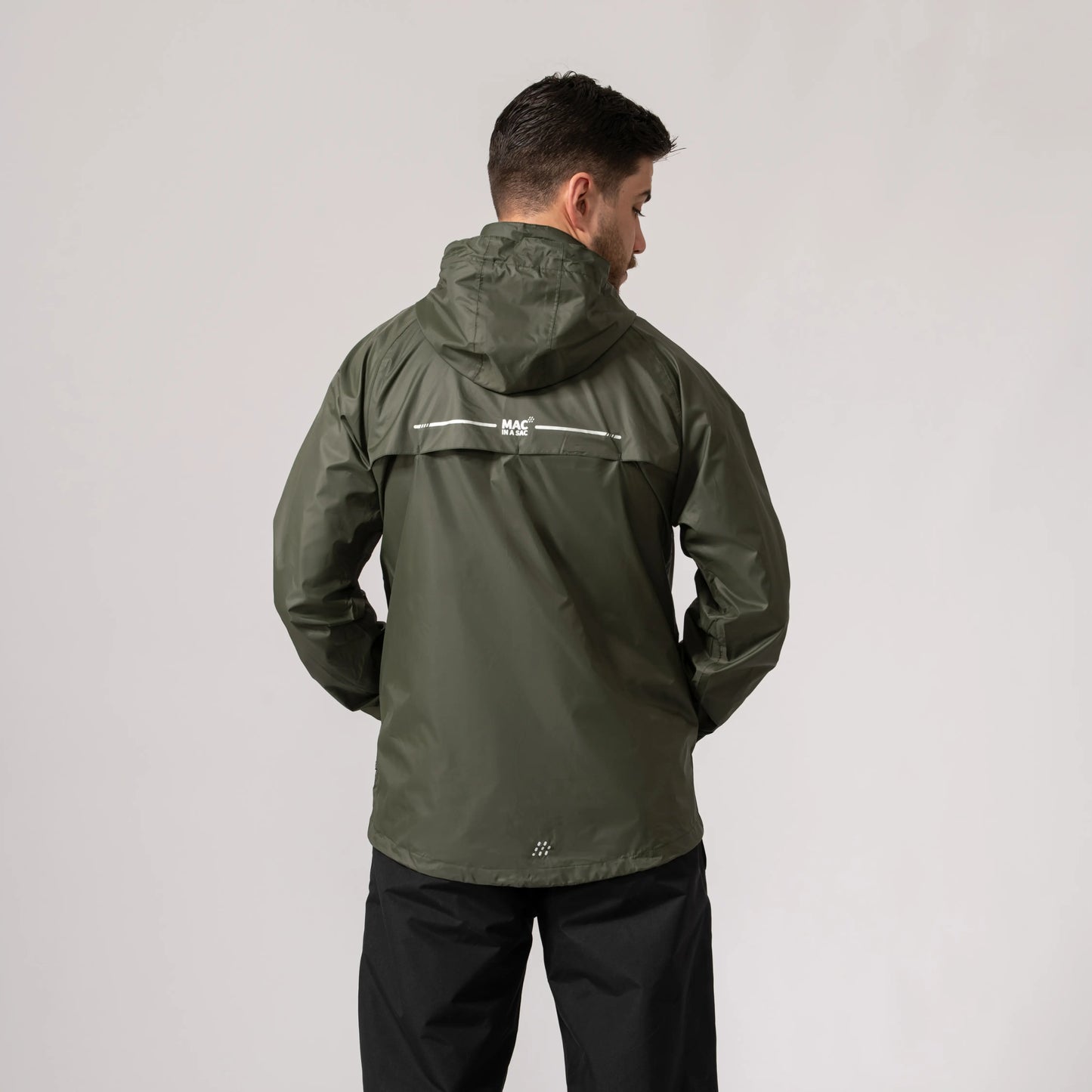 Person wearing a khaki waterproof and windproof jacket showing the back side with a visible brand logo on a light gray background