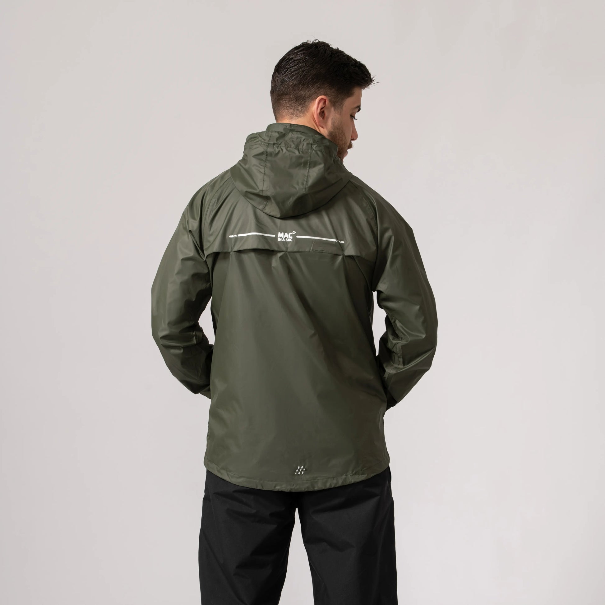Person wearing a khaki waterproof and windproof jacket showing the back side with a visible brand logo on a light gray background